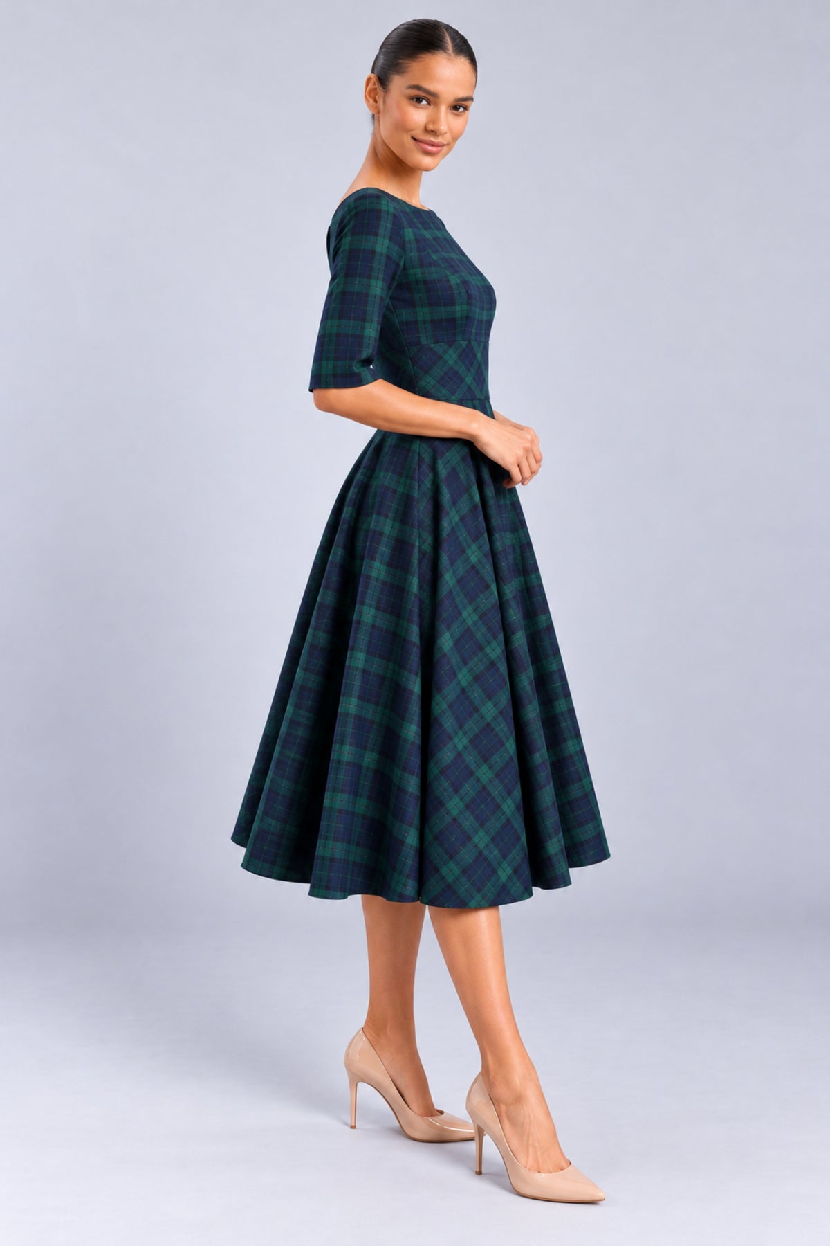 Side view of the Hepburn Forest and Navy Tartan Swing Dress, highlighting the tailored waist, mid-length sleeves and flowing skirt.