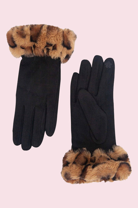 A pair of black gloves with leopard-print faux fur trim at the cuffs, displayed on a solid pale pink background.