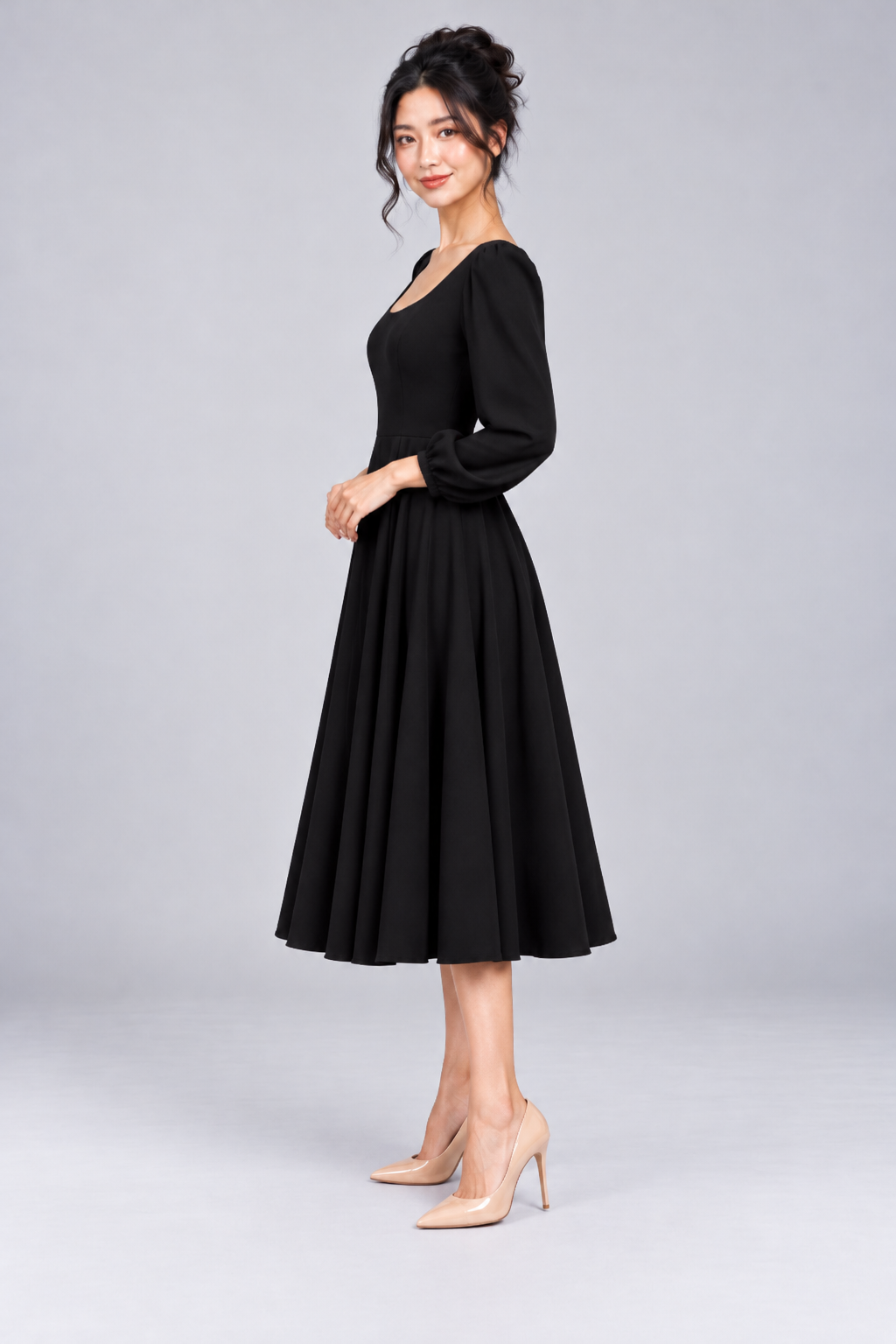 Side view of the Josette Black Corset Swing Dress showing the defined waist and flowing midi-length skirt.
